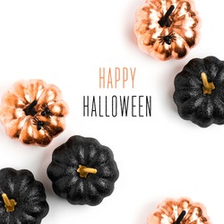 Happy Halloween Card. Stylish  background with black and gold Halloween pumpkin. isolated on white background. Flat lay, top view. 