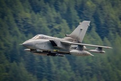 Tornado fighter jet flying fast at low level in the mountains of the United Kingdom. 