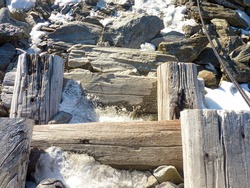 staircase of wooden poles damaged by bad weather and frost. High quality photo