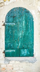 old wooden door painted green, ruined by time. High quality photo