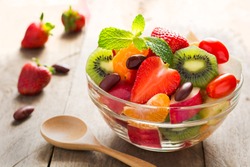 Diet-Fresh tasty mix fruit salad in the bowl on the wooden table, healthy breakfast, weight loss concept