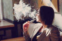 young woman smoking electronic cigarette