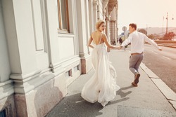 gorgeous wedding couple walking in the old city of Budapest 