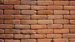 Nice old brick wall for background. Macro shot.Seamless masonry clay block vintage style.Background construction backdrop brickwork rustic materials orange color.Retro grunge tilable surface Aged.