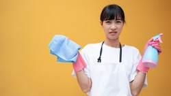 Asian woman house cleaning outfit, wearing rubber gloves and a bottle of various household cleaning chemicals.
Tired of cleaning the house.Idea banner cover design.