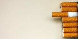 A pack of cigarettes on a white background. open pack of cigarettes. Yellow filter. Harm to health. It is a bad habit. The concept of World No Tobacco, Tobacco and Lung Health. Cigarettes in a tutu