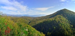 Green mountain Akhun among autumn trees in Sochi National Park. Krasnodar Territory, Russia, 2021