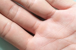 Macro human hand,Macro image of the surface texture of the human palm,Close up skin texture with wrinkles on body human,Hand closeup view