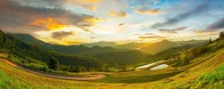 panoramic view of mountains and sky,Forested hills in rising fog. Mountain sunset hills.