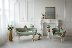 Vintage green armchairs in the interior near the fireplace