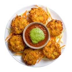 Mix veg pakora with tomato mint sauce isolated on white background top view