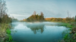 Fabulous colorful spring morning. A bend in the Dubysa river, Lithuania. Wonderful panoramic photo of a spring landscape. Fog rising from the river, spring nature, meditation and peace. Wide panorama