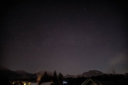 Winter time stars with mountains and houses