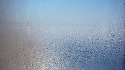 Glass with water vapor, fog, flow. a window with water drops. fogged glass 