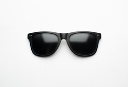 Vintage sunglasses with black plastic frame on white background