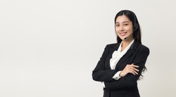 Happy young asian business woman call centre. Welcome female operator put on smalltalk headphone standing on isolated white background.