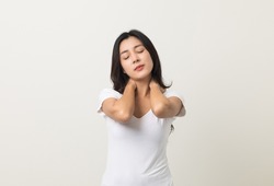 Asian woman has problem with structural posture She had neck and shoulder pain. She massaged her neck and shoulders for relief. reduce muscle tension. Standing on isolated white background