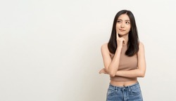 Beautiful young asian woman in brown shirt. Charming female lady standing pose thinking on isolated white blank background. Asian cute people looking copy space for text advertise