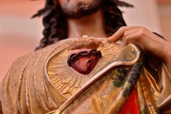 Sacred Heart of Jesus Christ Statue close-up. Jesus shows his own heart, symbol of God's love