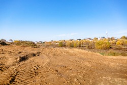 Land reclamation for property development. Sale of land at auction. Commercial building. Leveling, adding soil to the site. Land cleaning work. The first stage of lawn planting. Building area. Banner.