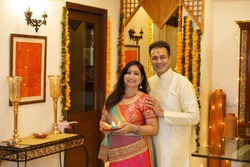 Couple in tradional wear at home in standing pose
