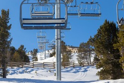 Chairlift line at a winter resort in the mountains.