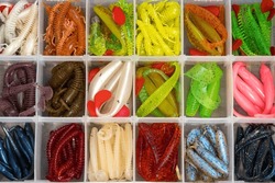 Box with soft fishing lures for catching predatory fish. Fishing set with silicone tips.