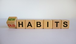 Turned cube and changed the expression 'old habits' to 'new habits'. Beautiful white background. Concept. Copy space.