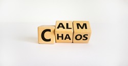 Stop chaos, time to calm. The words 'chaos' and 'calm' on wooden cubes. Beautiful white background, copy space. Business and chaos or calm concept.