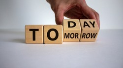 Do it today, not tomorrow. Male hand flips wooden cubes and changes the word 'tomorrow' to 'today'. Beautiful white background, copy space. Business and tomorrow or today concept.