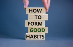 Build good habits symbol. Wooden blocks with words 'how to form good habits'. Male hand. Beautiful grey background, copy space. Business, psychological and build good habits concept.