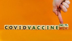 Covid vaccine myths or facts symbol. Hand turns cubes and changes words 'covid vaccine myths' to 'covid vaccine facts'. Beautiful orange background, copy space. Covid-19 vaccine and medical concept.