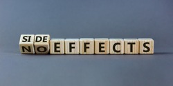 Side or no effects symbol. Turned wooden cubes and changed words 'no effects' to 'side effects'. Beautiful grey background, copy space. Medical, covid-19 pandemic corona side effects concept.