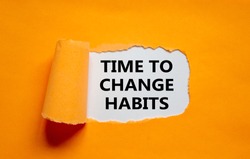 Time to change habits symbol. The text 'Time to change habits' appearing behind torn orange paper. Business, growth and time to change habits concept. Copy space.