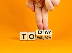 Do it today, not tomorrow. Male hand flips wooden cubes and changes the word 'tomorrow' to 'today'. Beautiful orange background, copy space. Business and tomorrow or today concept.