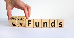 Mutual funds vs ETF symbol. Businessman turns a cube and changes words 'ETF, Exchange-Traded Fund' to 'Mutual funds. Beautiful white background, copy space. Business and ETF vs mutual funds concept.