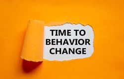 Time to behavior change symbol. The text 'Time to behavior change' appearing behind torn orange paper. Business, growth and time to behavior change concept. Copy space.
