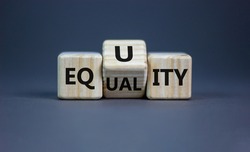 Equality or equity symbol. Turned a cube and changed the word 'equality' to 'equity'. Beautiful grey background. Psychology, business and equality or equity concept. Copy space.