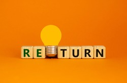 Return symbol. Wooden cubes with word 'return'. Yellow light bulb. Beautiful orange background. Business and return concept. Copy space.
