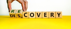 Recovery or discovery symbol. Businessman turns wooden cubes, changes a word 'discovery' to 'recovery'. Beautiful white background. Business and discovery or recovery concept. Copy space.