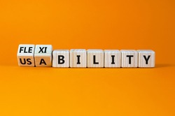 Flexibility and usability symbol. Turned wooden cubes and changed words 'usability' to 'flexibility'. Beautiful orange background, copy space. Business, flexibility and usability concept.