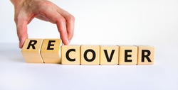 Time to recover symbol. Businessman turns wooden cubes and changes the word 'cover' to 'recover'. Beautiful white background. Business, cover or recover concept. Copy space.