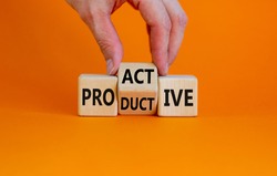Proactive and productive symbol. Businessman turns cubes and changes the word 'productive' to 'proactive'. Beautiful orange background, copy space. Business, proactive and productive concept.