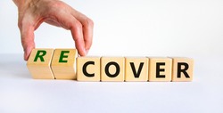 Time to recover symbol. Businessman turns wooden cubes and changes the word 'cover' to 'recover'. Beautiful white background. Business, cover or recover concept. Copy space.