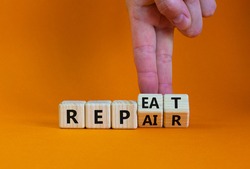 Repeat and repair symbol. Businessman turns wooden cubes and changes the word 'repeat' to 'repair'. Beautiful orange table, orange background, copy space. Business, repeat and repair concept.