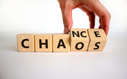 Chance or chaos symbol. Businessman turns wooden cubes and changes the word 'chaos' to 'chance'. Beautiful white background, copy space. Business, chaos or chance concept.