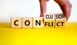 Conflict or conclusion symbol. Businessman turns wooden cubes, changes the word 'conflict' to 'conclusion'. Beautiful yellow and white background, copy space. Business, conflict or conclusion concept.