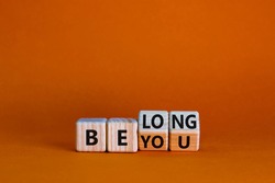 Be you, belong symbol. Turned cubes and changed words 'be you' to 'belong'. Beautiful orange background. Business, belonging and be you, belong concept. Copy space.