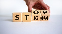 Stop stigma symbol. Doctor turns cubes with words stop stigma. Beautiful white background. Medical and stop stigma concept. Copy space.