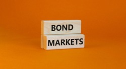 Bond markets symbol. Wooden blocks with words 'Bond markets' on beautiful orange background, copy space. Business and bond markets concept.